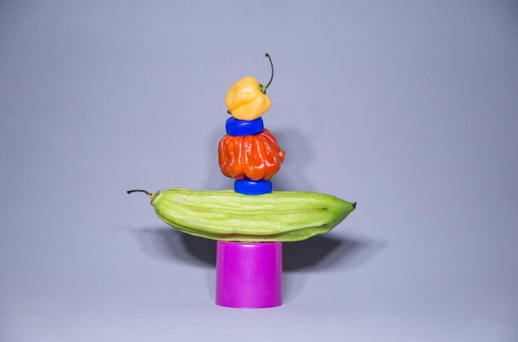 फोटो close-up of vegetables and lids stacked against gray background