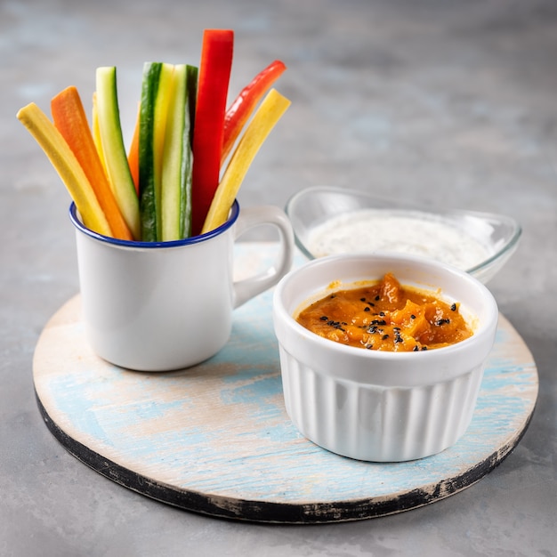 Close up of vegetables stick with pumpkin dip