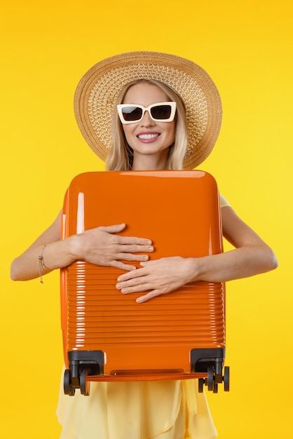 Close up vertical photo of young woman over isolated yellow background in vacation