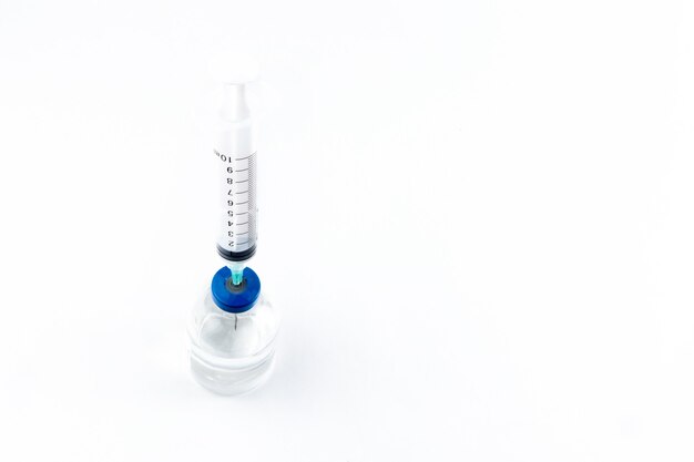 Close-up of the vial and the syringe to place the vaccine on a white background. isolated