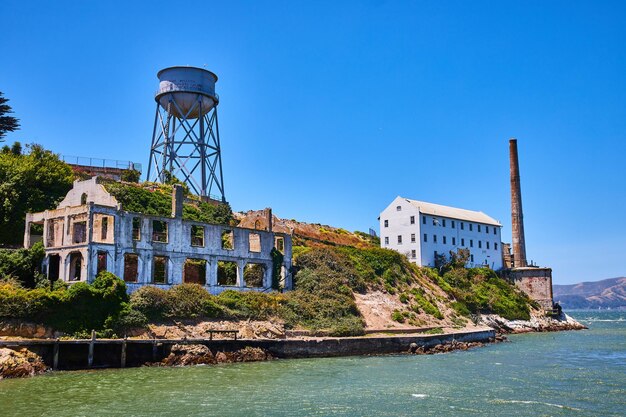 Close up view of abandoned and decaying building on alcatraz island with water tower