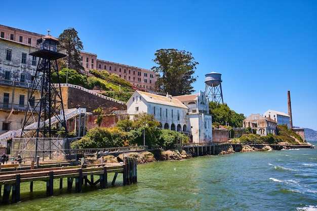 Close up view of Alcatraz Island shoreline lined with buildings and prison