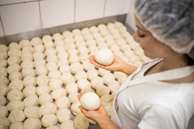 Close up view of baker hands kneading and preparing dough or bred for baking