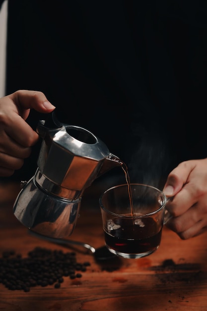 Close up view barista pouring fresh coffee from Moka pot