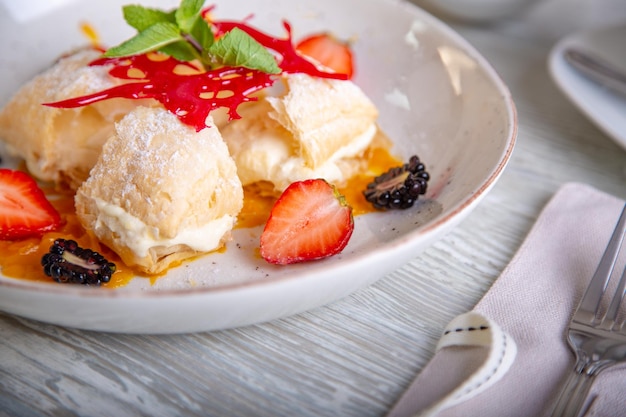 Close up view of beautiful elegant sweet dessert served on the plate Beautiful decoration restaurant dish ready to eat Tea time cozy atmosphere