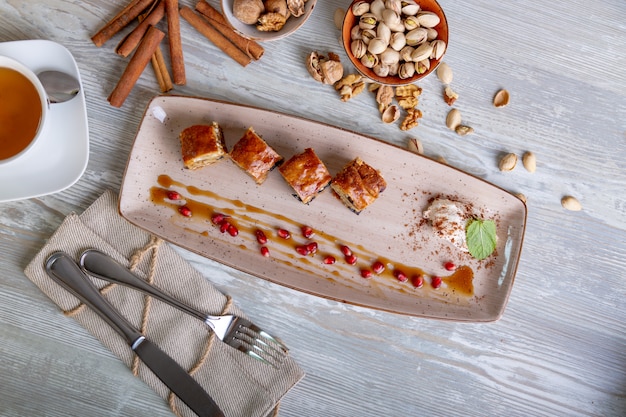 Close up view of beautiful elegant sweet dessert served on the plate. Beautiful decoration, restaurant dish, ready to eat. Tea time, cozy atmosphere.