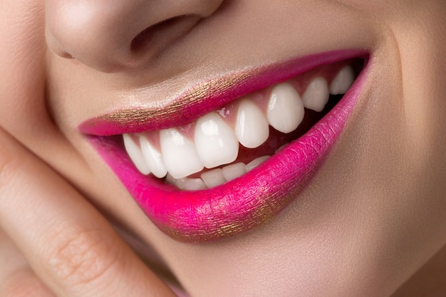 Close up view of beautiful smiling woman lips with fashion make up.