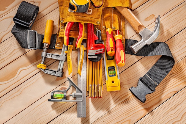 Close Up View Big Set Of Carpenter Tools In Leather Tool Belt On Background Of Wooden Beams