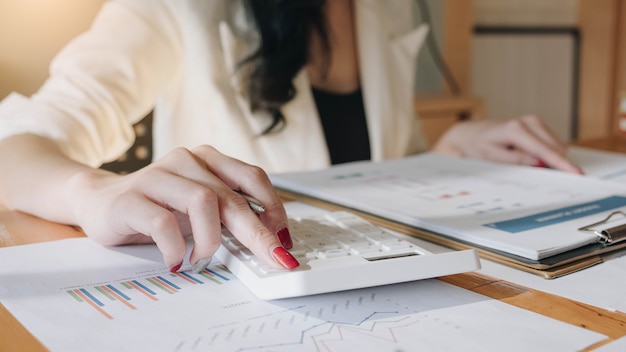 Close up view of bookkeeper or financial inspector hands making report, calculating or checking balance.