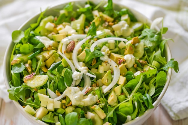 Close up view of a bowl of green healthy salad