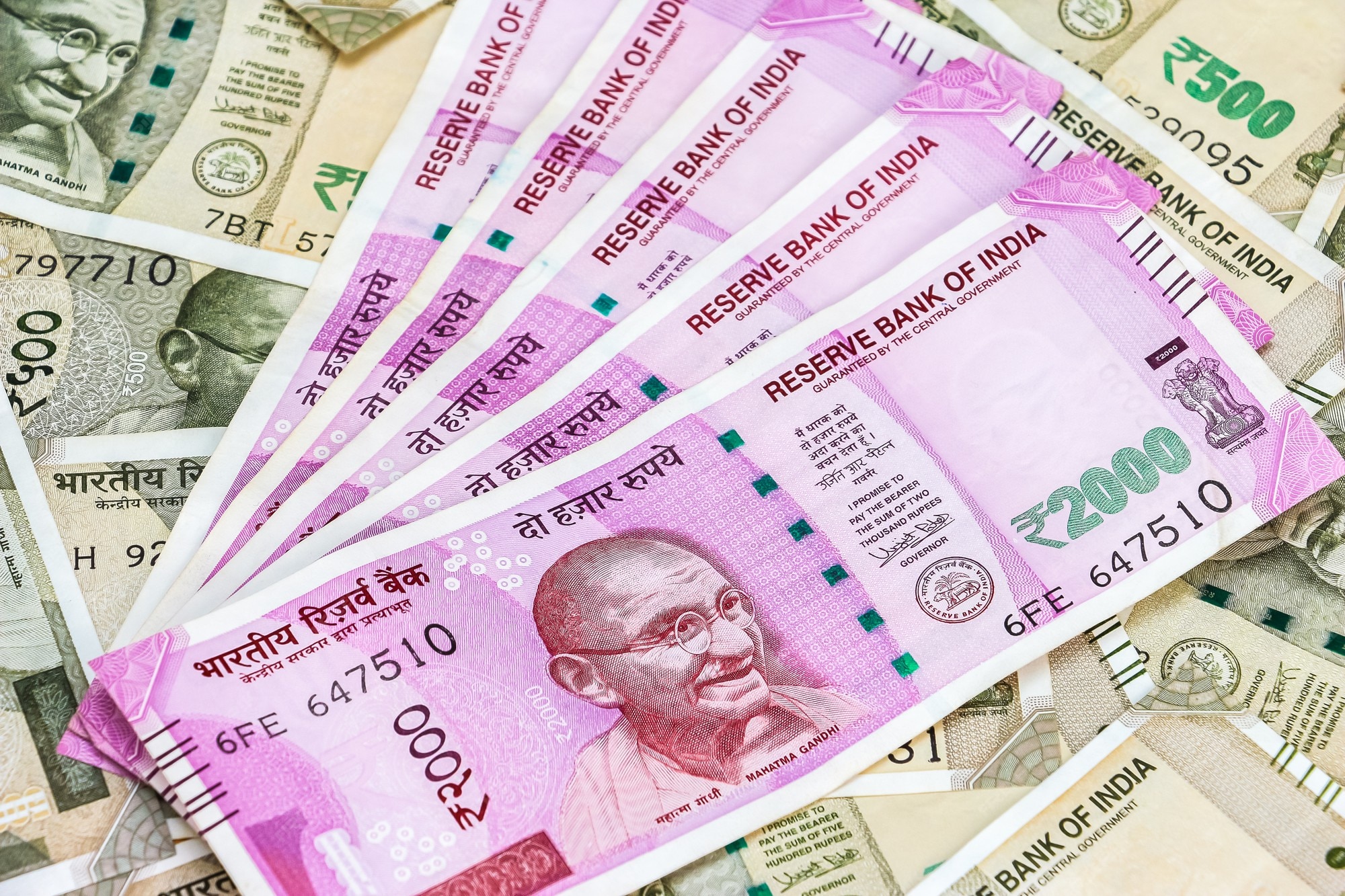 premium-photo-close-up-view-of-brand-new-indian-2000-rupees-banknotes