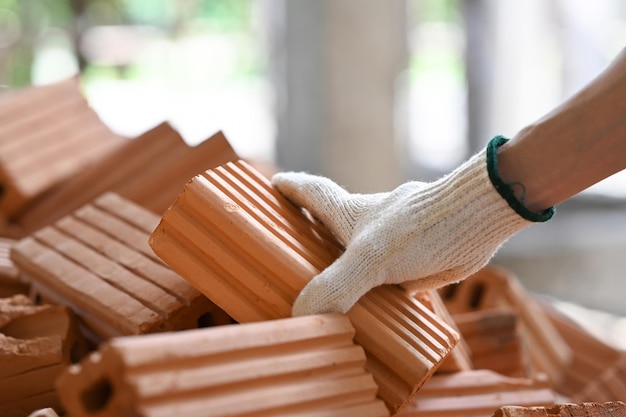 Close up view of bricklayer working on construction site Concept of repair and building materials