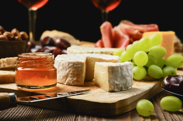 Close up view of brie cheese on plate with snack for wine