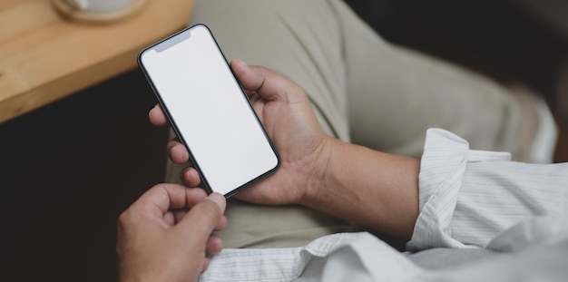 Close-up view of businessman holding blank screen smartphone