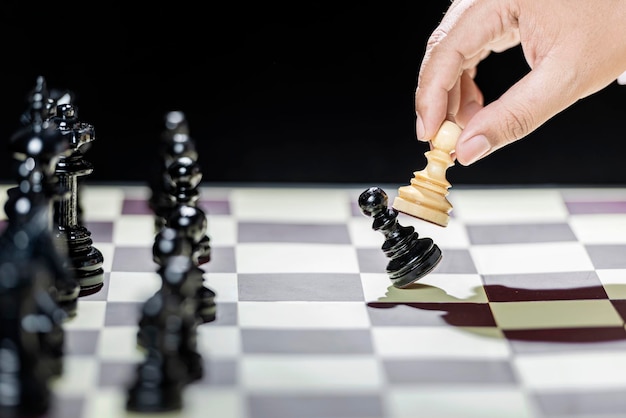 Close up view of the businessman playing chess