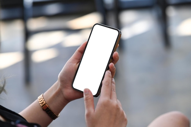 Close up view businesswoman sitting in office and using smart phone