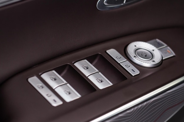 Close up view of button controlling window in modern car
interior vehicle interior detail door handle with windows
controls