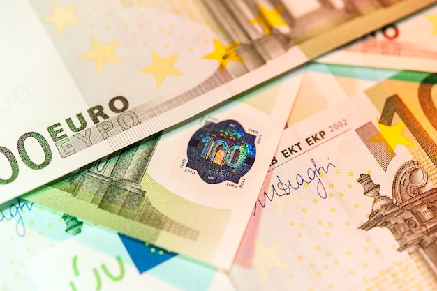 Close-up view of cash money euro bills background. Finance and business concept. Close up of security hologram on banknotes. Shallow depth of field.