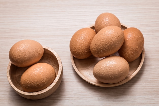 Close-up view of chicken eggs on wooden tabl