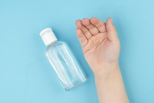 Close up view of child's hand using small portable antibacterial hand sanitizer. Prevention of viral diseases