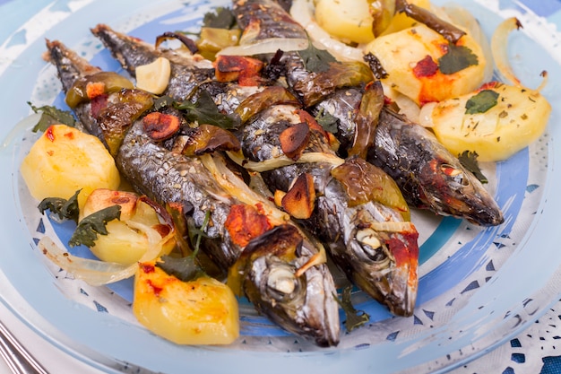 Close up view of cooked mackerel fish with potato. 