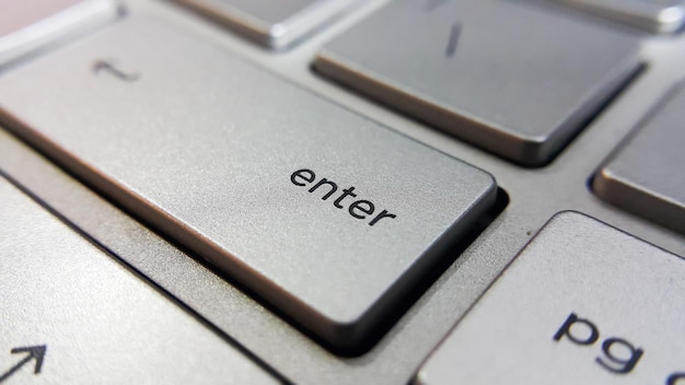 Close up view of enter key button on computer laptop keyboard