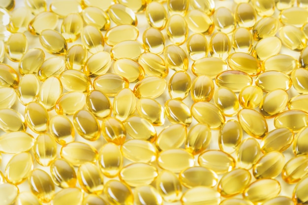 Close up view, evening primrose oil capsules. Alternative medicine and health care concept.