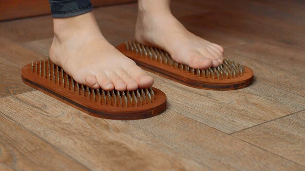 Close up view f woman standing on nails media practice of standing on nails concept of feelings