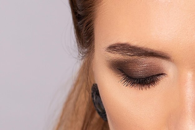 Close up view of female eye with brown makeup