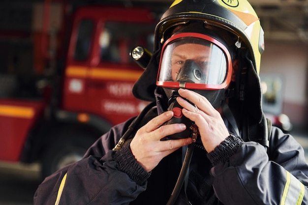 Close up view Female firefighter in protective uniform standing near truck