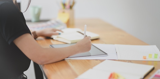 Close-up view of female graphic designer working on her project 