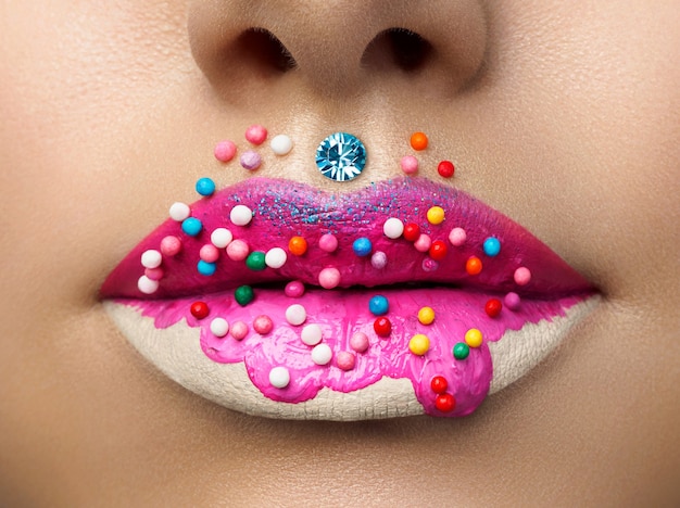 Close up view of female lips with sweet donut makeup. Fashion make up, dessert or junk food concept. Macro studio shot