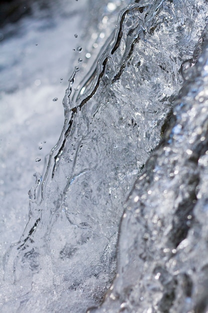 Close up view of a fresh stream of water on the forest.