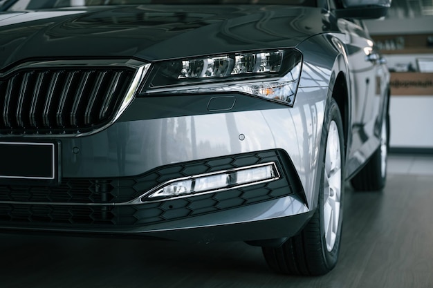 Close up view of front part of modern black automobile in car dealership