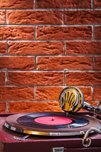 Close up view on gramophone on background of the brickwall