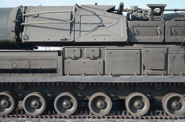 Close up view of green armoured caterpillar transport. Modern military transportation vehicle technologies