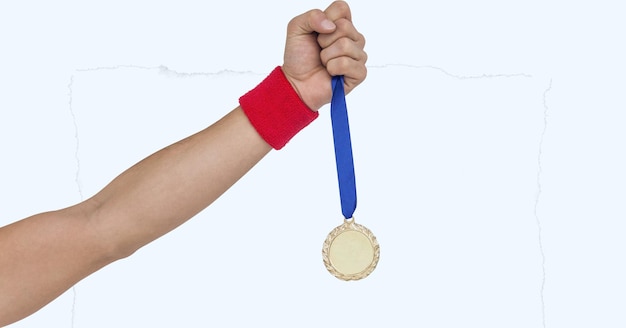 Close up view of hand holding a medal against white background