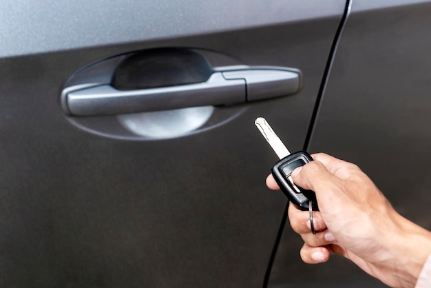 Close up view of hand holding a remote key for opening car