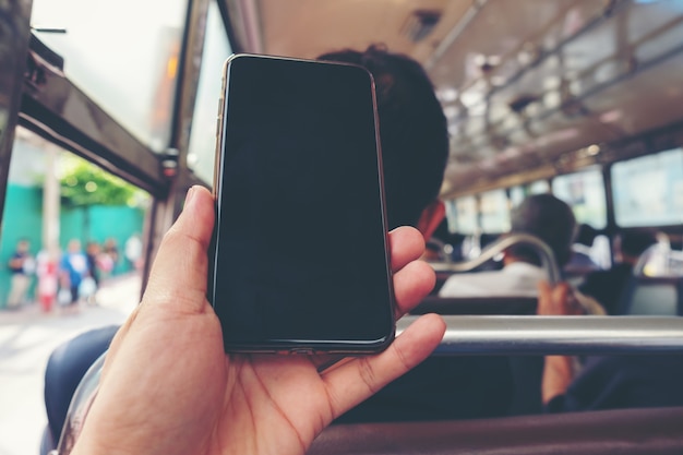 Close up view on the hands of a young hand man show mobile phone or smartphone blank scree