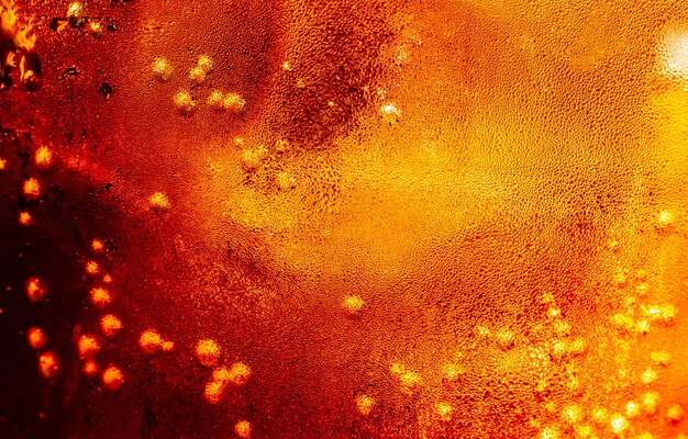 Close up view of the ice cubes in dark cola background Texture of cooling sweet summers drink