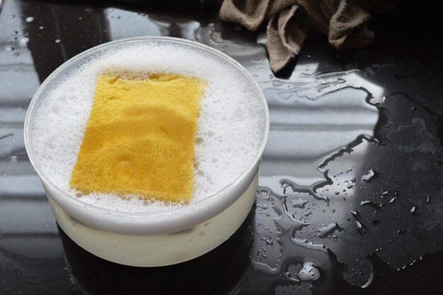 Close up view of kitchen sponge and soapy foam