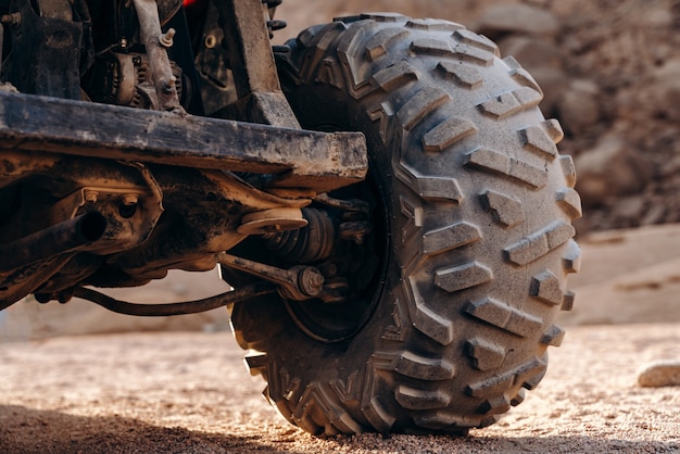 Close up view of a large ATV wheel in the desert