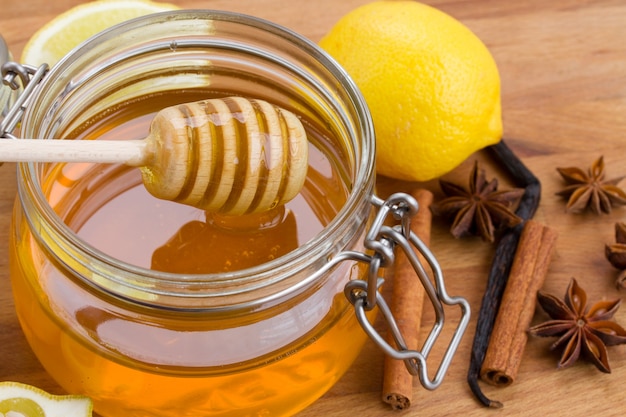 Close up view of lemons and a jar of honey