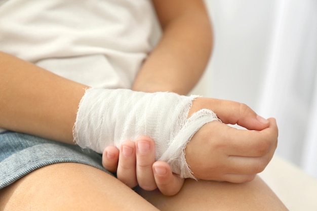 Close up view of little girl's wrist with applied bandage