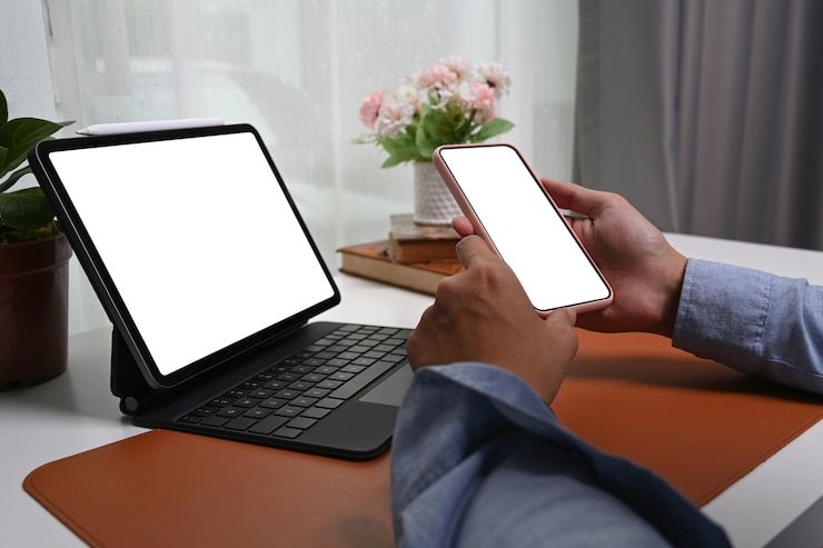 Photo close up view man hands holding mock up mobile phone with empty screen.