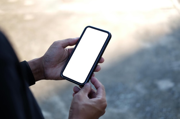 Close up view man holding mock up mobile phone with blank screenx9