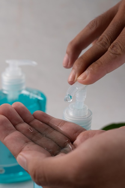 Close up view of man using antibacterial hand sanitizer in\
hands