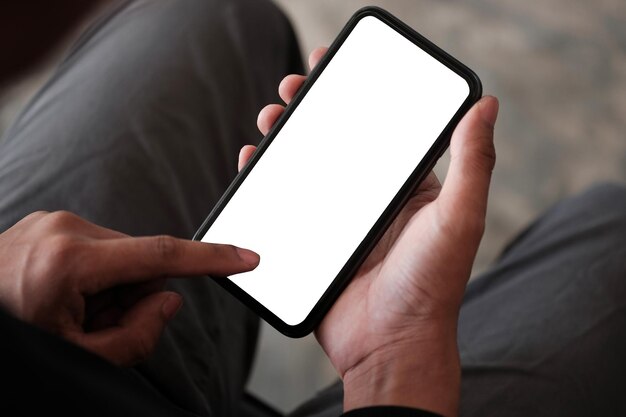 Close up view man using mobile phone in living roomx9xA