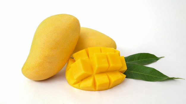 Close up view of mangoes fruit and mango cut in cubes isolated