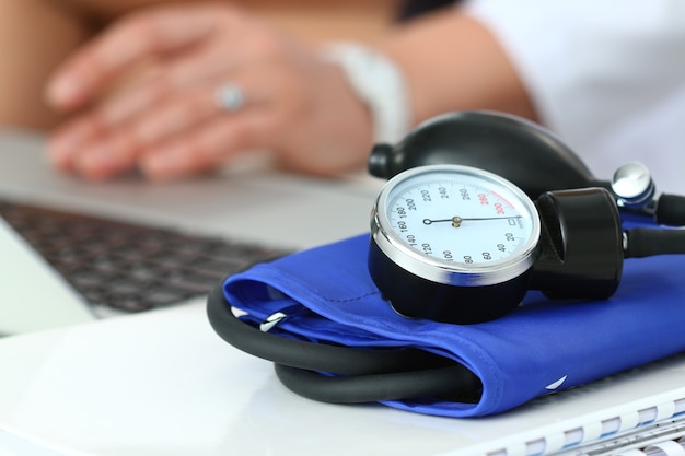 Close up view of manometer laying on working table. Hospital workspace. Healthcare, medical service, treatment, hypotonia or hypertension concept